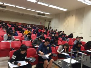 students sit in classroom and take test